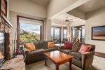 Guests will enjoy the open living space, high ceilings, and mountain views